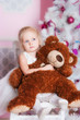 The girl at the Christmas fir-tree with gifts