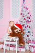 The girl at the Christmas fir-tree with gifts