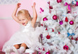 The girl at the Christmas fir-tree with gifts