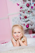 The girl at the Christmas fir-tree with gifts