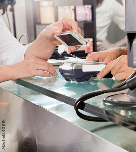 Photo: Customer Paying With Mobilephone Using NFC Customer Paying With Mobilephone Using NFC
