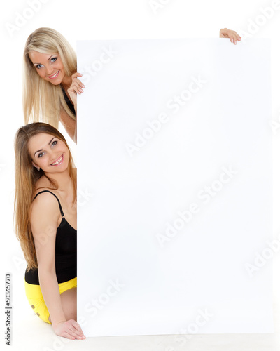 Photo: Young women with empty board for the text. Young women with empty board for the text.