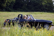 A young couple driving, man looking at a road map