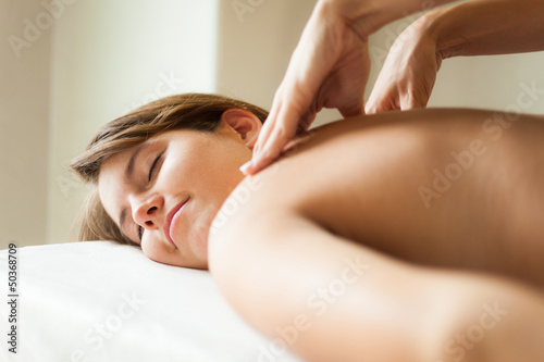 Photo: Young woman having a massage Young woman having a massage