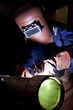 welder with protective eqipment in industrial hall