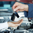 Key delivery between customer and mechanic in front of a car