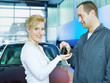 Key delivery between customer and mechanic in front of a car