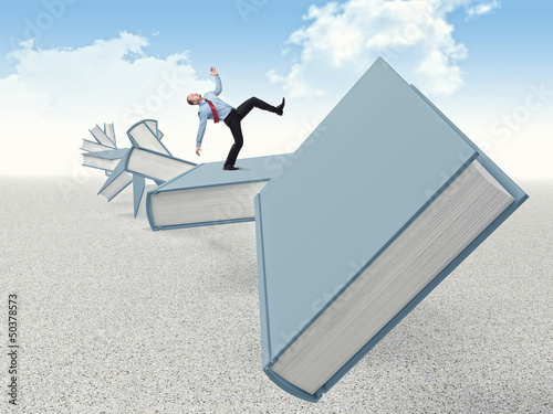 Photo: man on books man on books