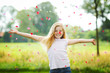 young girl throwing flower leaves