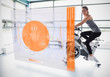 Young girl doing exercise bike with futuristic interface showing