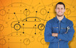 Young smiling mechanic standing in front of cars background
