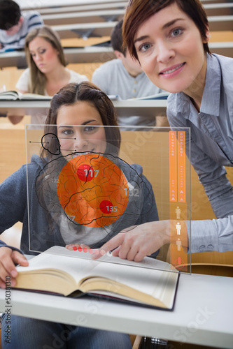 Photo: Student and teacher looking futuristic interface Student and teacher looking futuristic interface