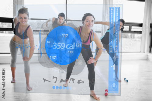 Photo: Women doing exercises with trainer while looking futuristic inte Women doing exercises with trainer while looking futuristic inte