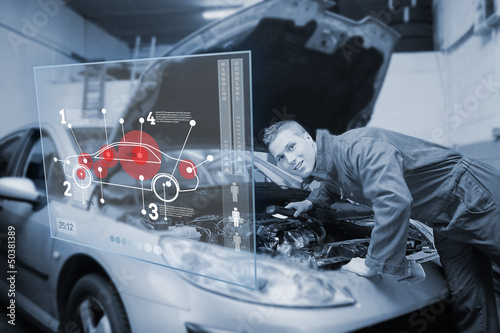 Photo: Mechanic with open hood consulting interface in black and white Mechanic with open hood consulting interface in black and white