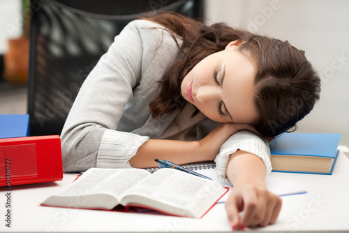 Photo: bored and tired woman sleeping on the table bored and tired woman sleeping on the table