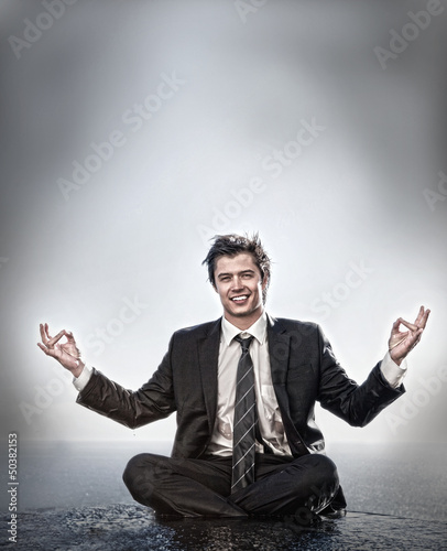 Photo: Businessman meditating and smiling Businessman meditating and smiling