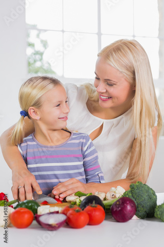 Photo: Mother teaching cutting vegetables Mother teaching cutting vegetables