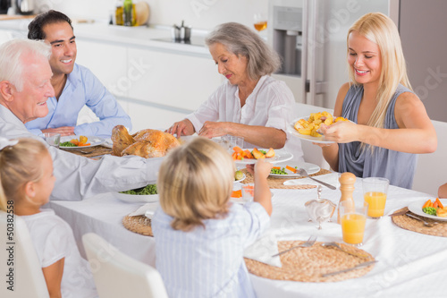 Photo: Happy Family eating the thanksgiving dinner Happy Family eating the thanksgiving dinner