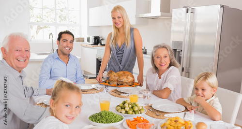 Photo: Happy mother serving a turkey Happy mother serving a turkey