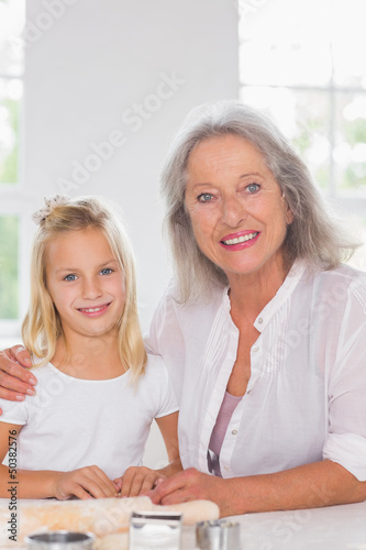 Photo: Grandmother and granddaughter looking at camera Grandmother and granddaughter looking at camera