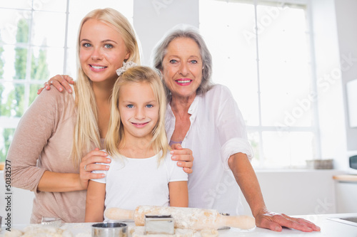 Photo: Cheerful mothers and daughters cooking together Cheerful mothers and daughters cooking together
