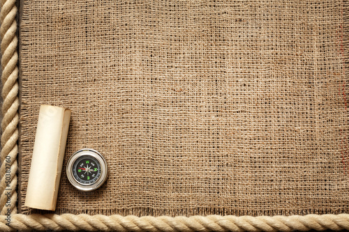 Photo: Old wooden planks and rope with compass vintage background Old wooden planks and rope with compass vintage background