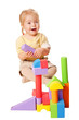 Photo: Baby girl building from toy blocks. Baby girl building from toy blocks.