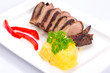Roasted duck breast with potatoes and red peppers