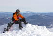 girl with snowboard on top of mountain