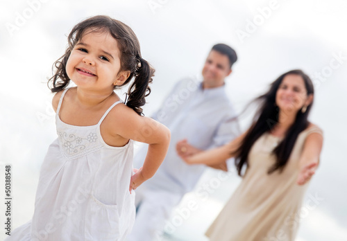 Photo: Happy girl with her family Happy girl with her family