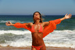 Beautiful tanned woman enjoying the sun on beach.