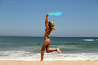 beautiful tanned woman running on the beach.