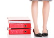 Businesswoman legs pile of ring binders reast break