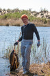 Happy lucky fisherman holding a big carp on river on fishing