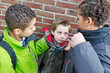 Two bullies bullying a small kid