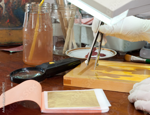 Photo: icon-painter works on new gilded icon icon-painter works on new gilded icon