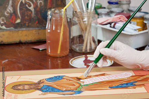 Photo: Iconographer paints of Christian icon Iconographer paints of Christian icon