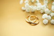 Gold wedding rings with flowers and copy space