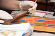 artist hands painting of new icon with brush