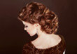 Hair. Wavy Hairstyle. Beautiful Girl with brown curly hair. Heal