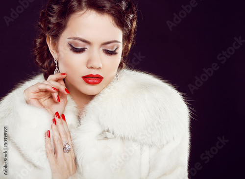 Photo: Glamour portrait of beautiful woman model in luxury fur coat ov Glamour portrait of beautiful woman model in luxury fur coat ov