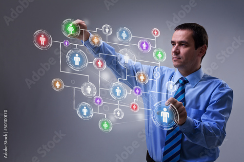 Photo: Businessman accessing modern social networking interface Businessman accessing modern social networking interface
