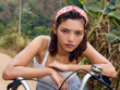 Girl with her hands on the handlebars.