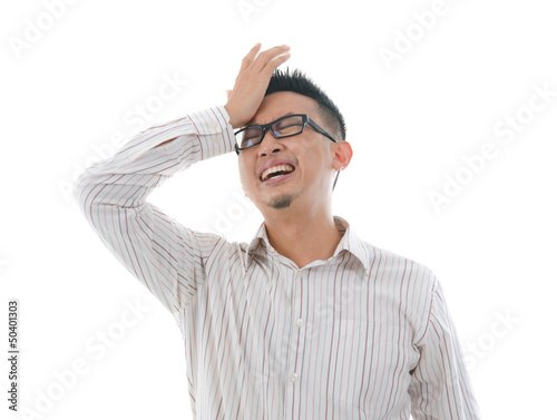 Photo: asian chinese male having headache with isolated white backgroun asian chinese male having headache with isolated white backgroun