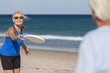 Senior Man Woman Couple Frisbee at Beach