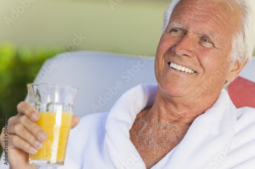 Photo: Senior Man In Bathrobe Drinking Orange Juice Senior Man In Bathrobe Drinking Orange Juice