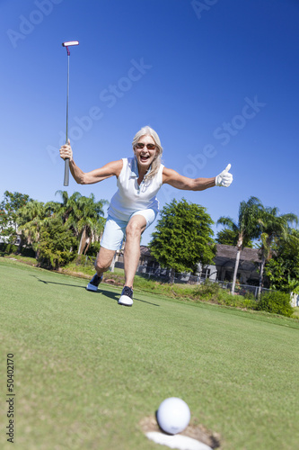 Photo: Happy Senior Woman Playing Golf & Putting Happy Senior Woman Playing Golf & Putting