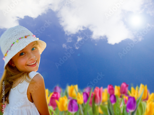 Photo: Spring garden, tulips -portrait of lovely girl in the garden Spring garden, tulips -portrait of lovely girl in the garden