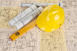 Yellow helmet, level and project drawings