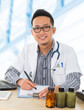 Asian medical doctor working on his desk